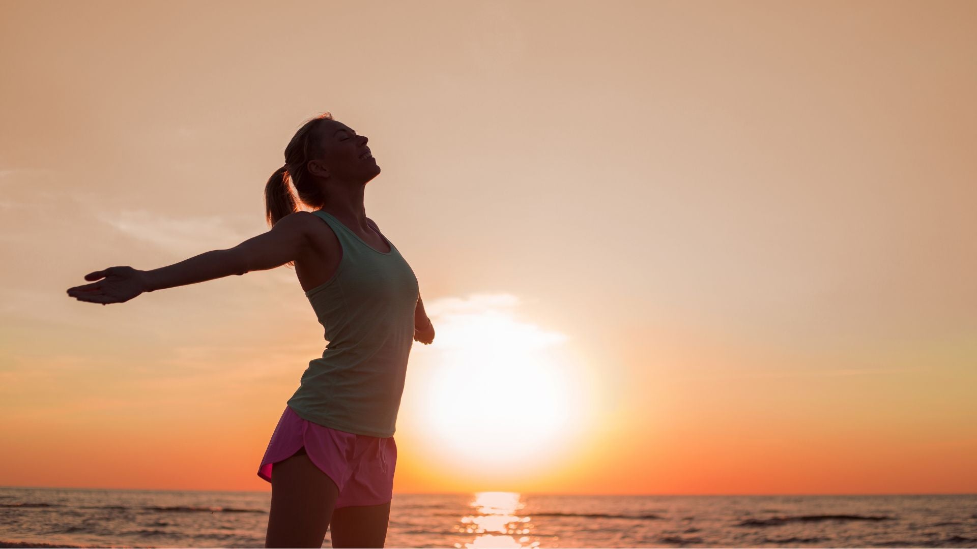 Woman enjoying fresh air at sunset for wellness and balanced lifestyle support