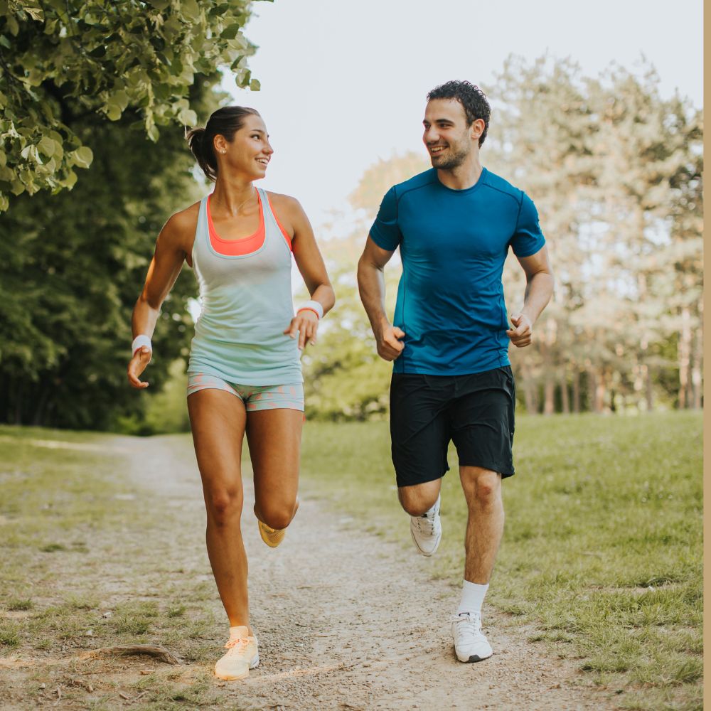 Man and woman running outdoors for energy, fitness, and healthy lifestyle support