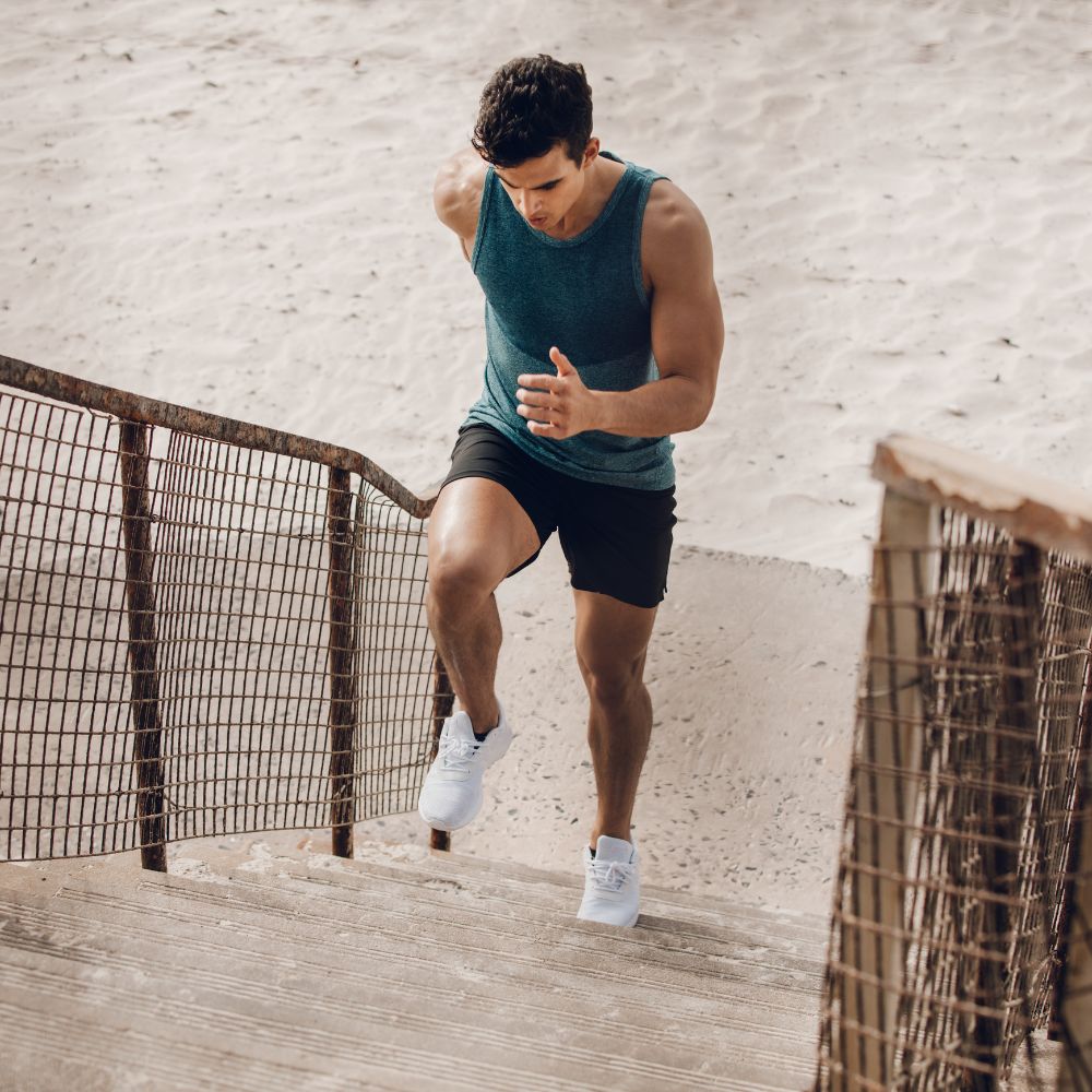 Man doing outdoor stair workout for endurance, strength, and fitness support
