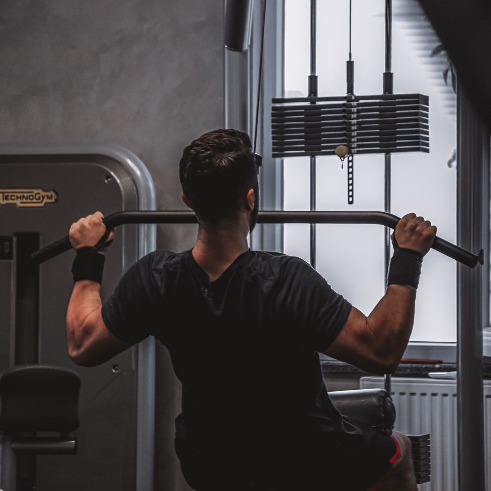 Man training in gym for muscle strength, fitness, and performance support