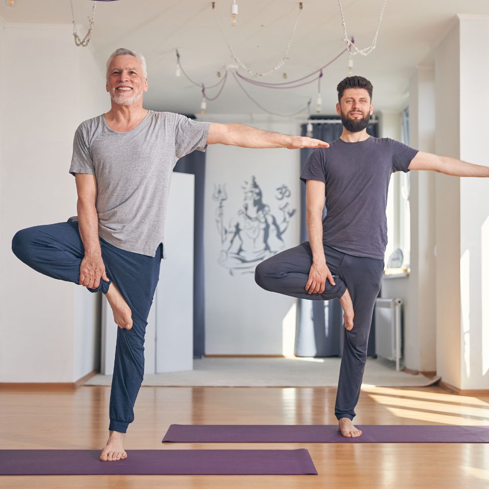 Men practicing yoga for balance, flexibility, and healthy aging support