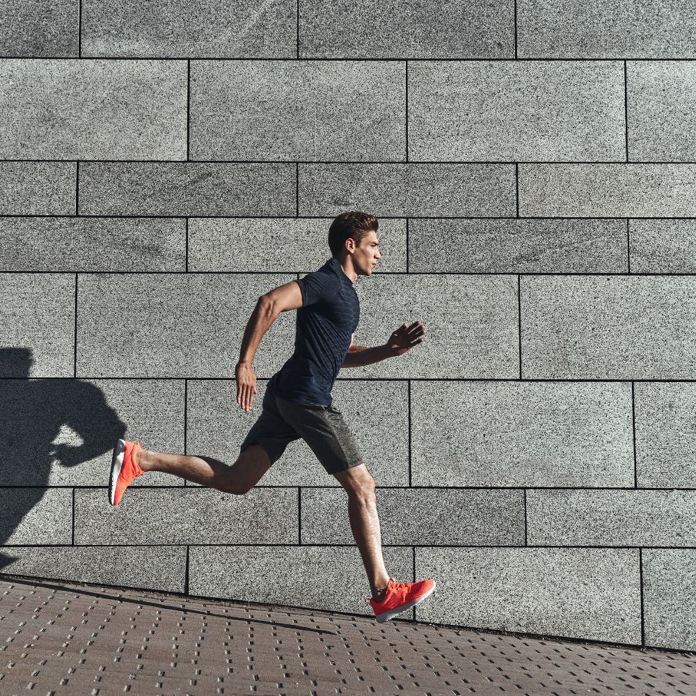 Man sprinting outdoors for speed, endurance, and fitness performance support