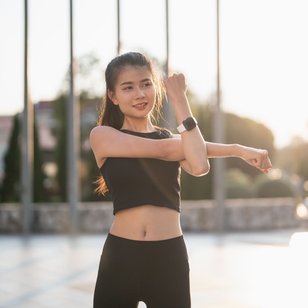 Woman stretching outdoors for fitness, flexibility, and daily wellness support